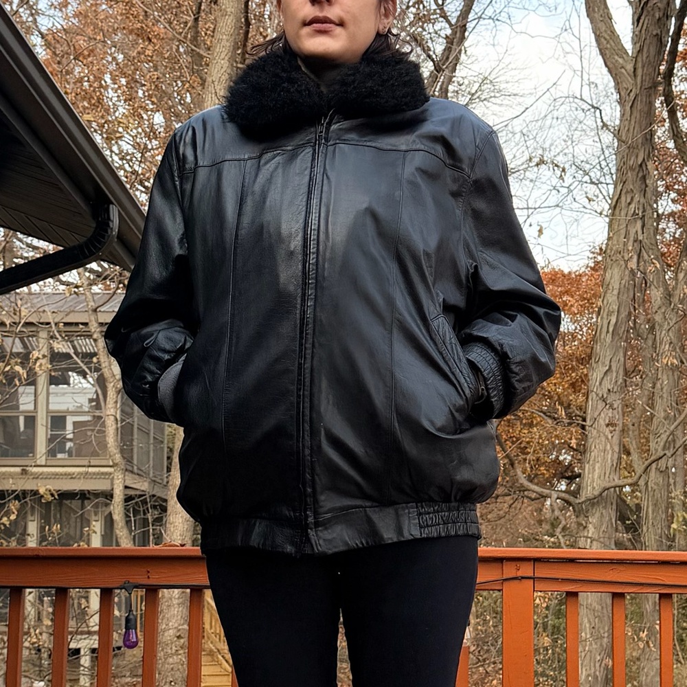 Women's Black leather jacket with fur vest attachment.